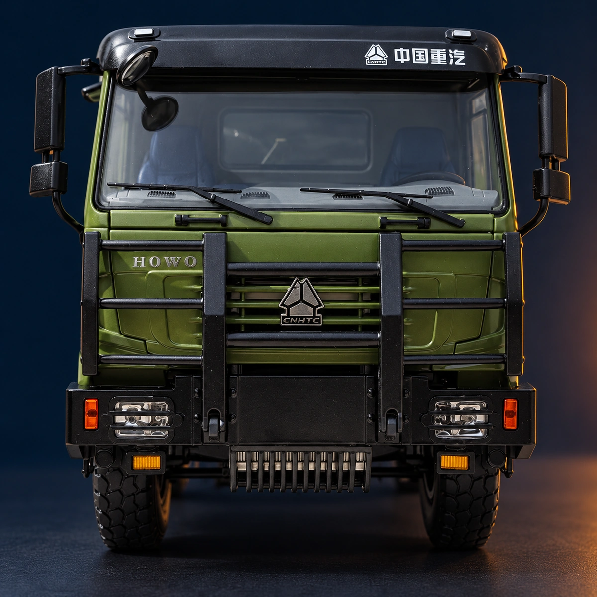Close view of HOWO lettering, the SINOTRUK emblem, front grille and black protective guard